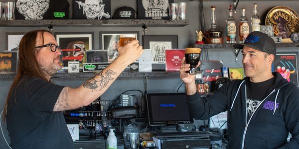 Two men drinking a beer at Wake Brewing in Rock Island