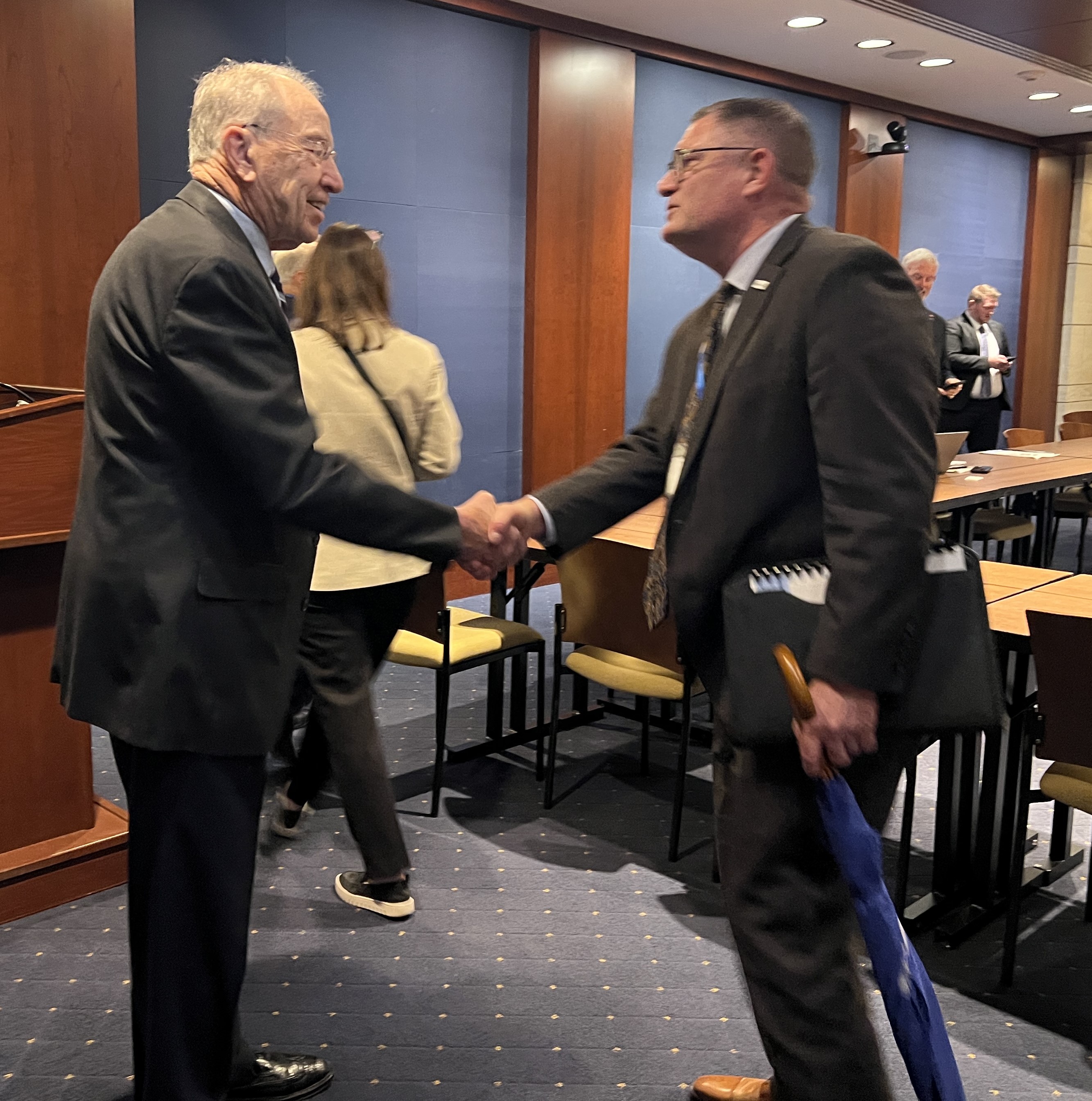 Mayor Bob Gallagher shakes hands with Senator Chuck Grassley