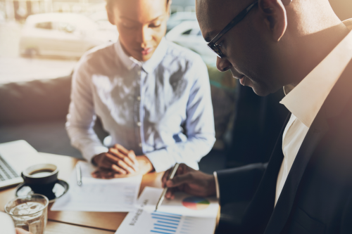 Two Black business people discussing business
