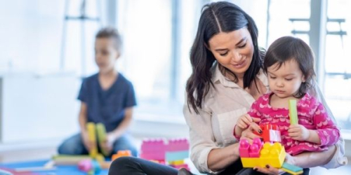 photo of woman holding a child