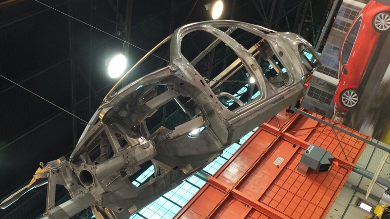 image of car body being built in a factory
