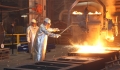 workers creating steel in a factory