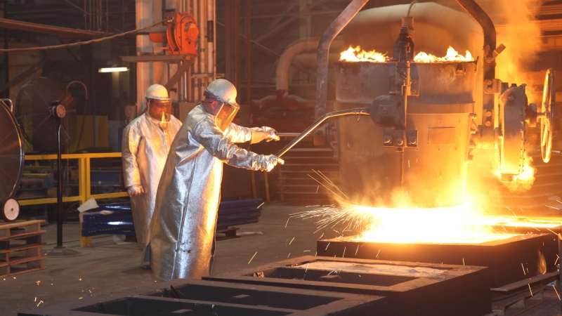 workers creating steel in a factory