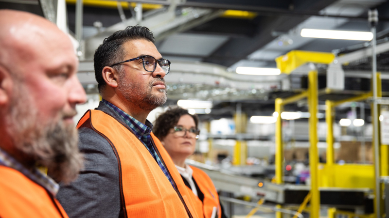 three people posing for a phot at Amazon