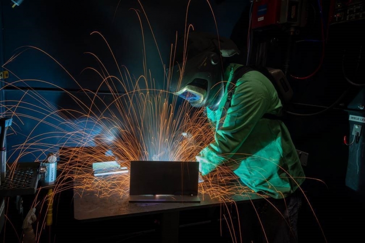 High school student welding at John Deere Davenport Works